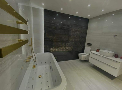 New shower and bathroom suite with gold accessories installed by Plumbers Rotherham
